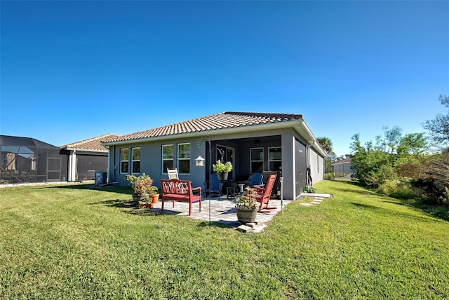 back of property featuring a patio and a lawn