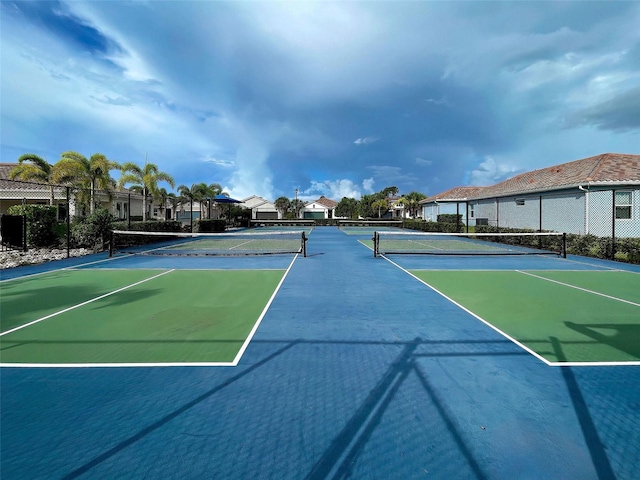 view of tennis court with basketball hoop