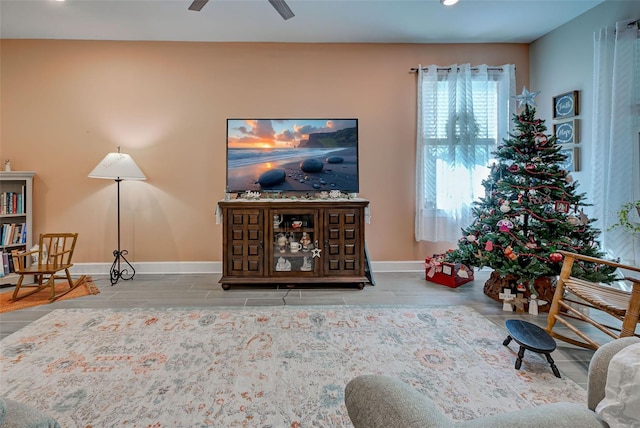 living room featuring ceiling fan and light hardwood / wood-style floors