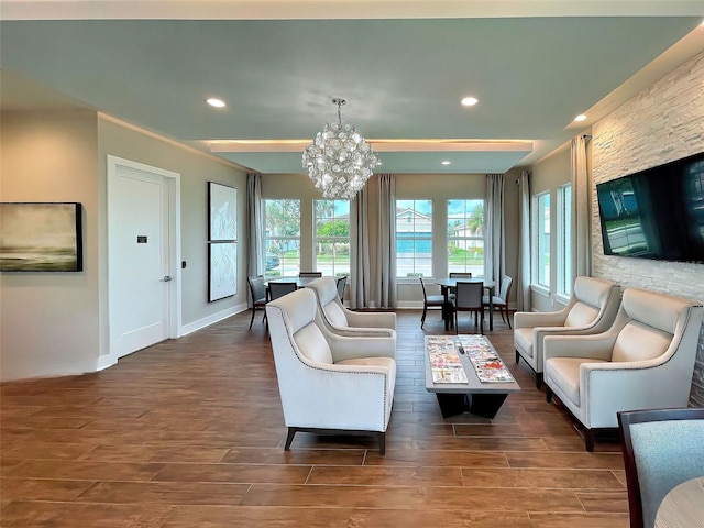 living room with dark hardwood / wood-style floors and an inviting chandelier