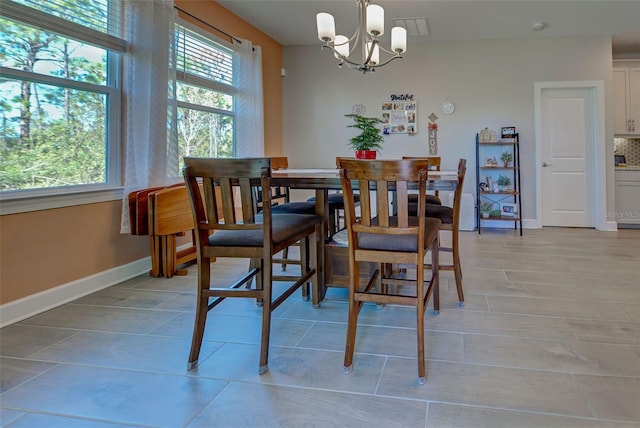 dining area featuring a notable chandelier