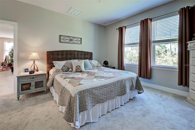 bedroom with light colored carpet