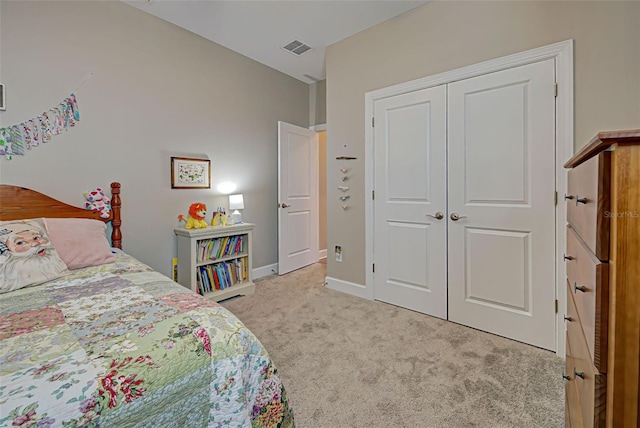 bedroom with a closet and light colored carpet