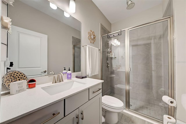 bathroom featuring vanity, toilet, and walk in shower