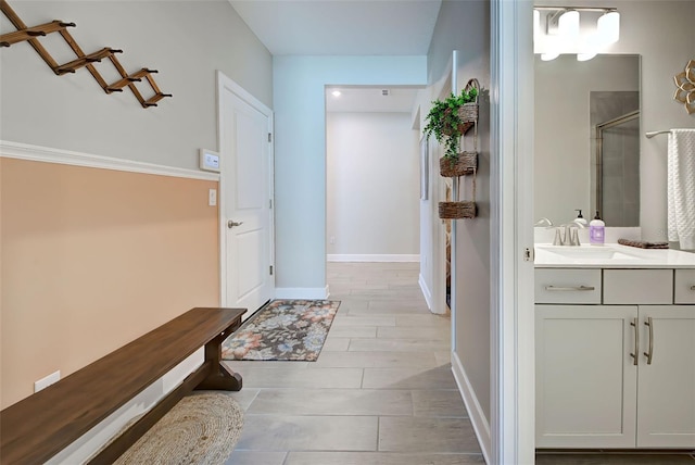 bathroom with hardwood / wood-style flooring, vanity, and a shower with shower door