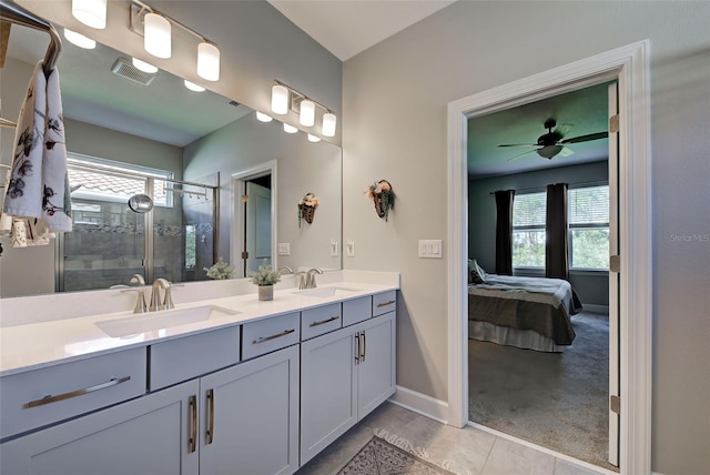 bathroom with vanity, plenty of natural light, a shower with shower door, and ceiling fan