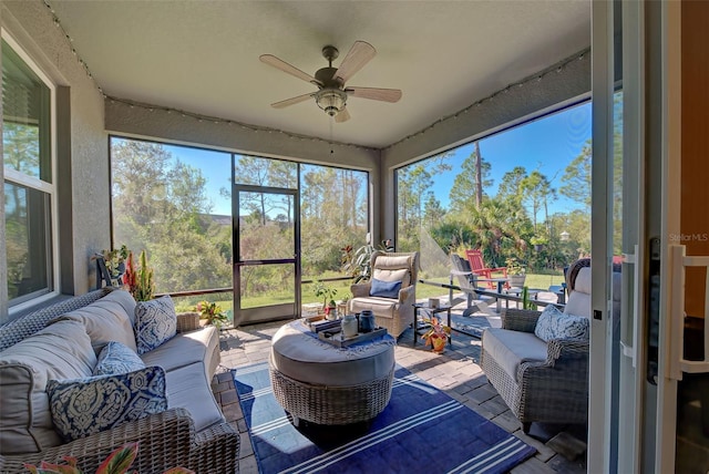 sunroom featuring ceiling fan