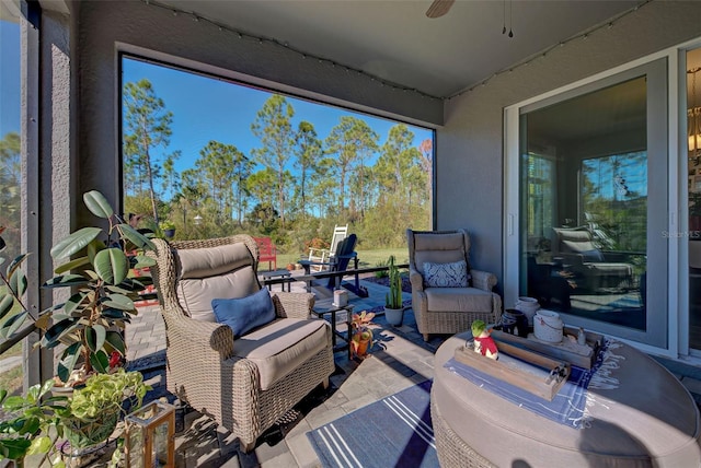 sunroom featuring ceiling fan