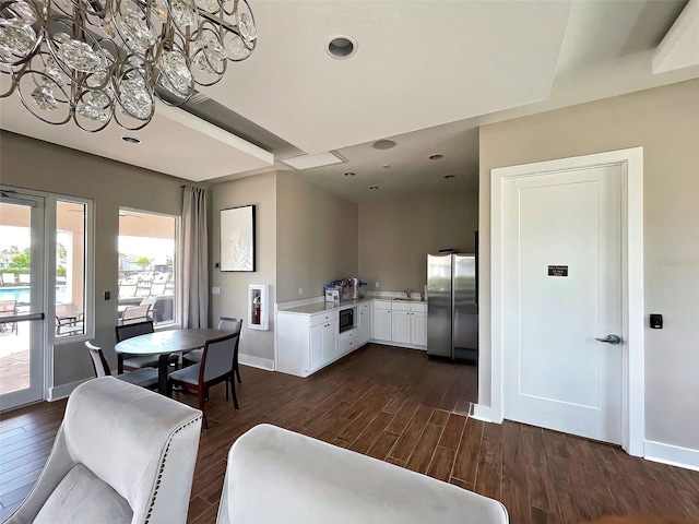 dining area with dark hardwood / wood-style flooring and sink