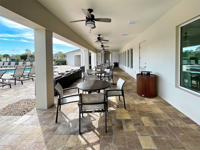 view of patio featuring outdoor lounge area, ceiling fan, and a swimming pool