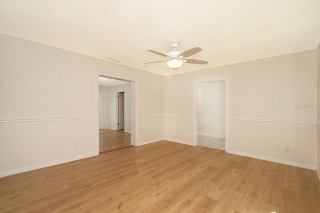 unfurnished room with light wood-type flooring and ceiling fan