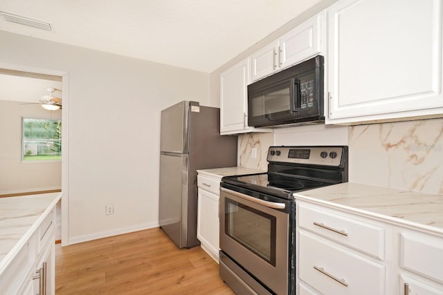 kitchen featuring light stone countertops, appliances with stainless steel finishes, ceiling fan, white cabinets, and light hardwood / wood-style floors