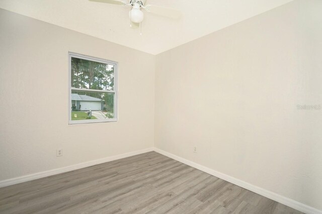 unfurnished room with ceiling fan and wood-type flooring