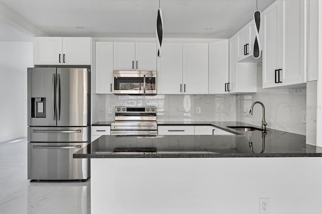 kitchen featuring white cabinets, stainless steel appliances, dark stone countertops, and sink