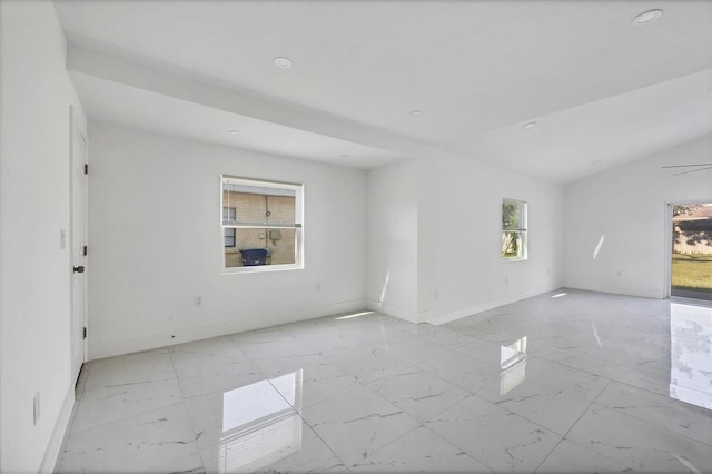 unfurnished room featuring a healthy amount of sunlight and lofted ceiling