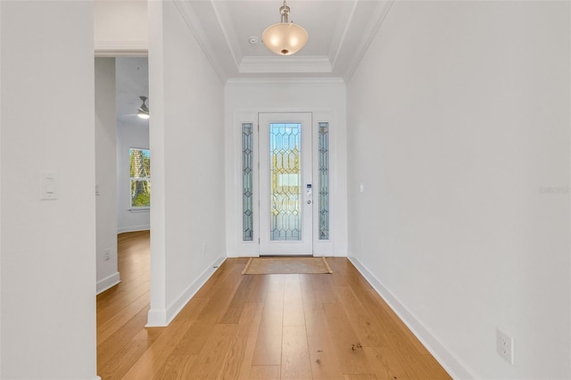 foyer with light hardwood / wood-style flooring and ornamental molding