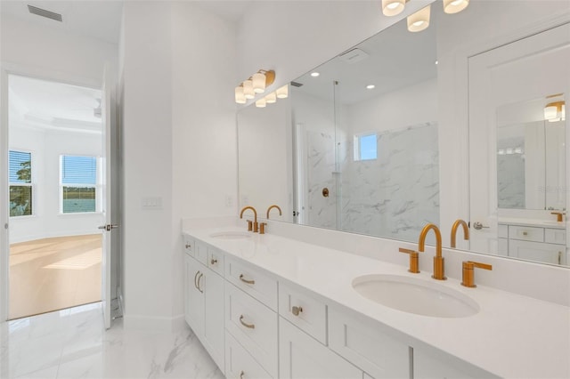 bathroom featuring walk in shower and vanity