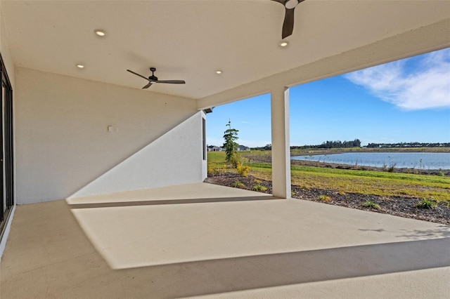 view of patio featuring ceiling fan and a water view