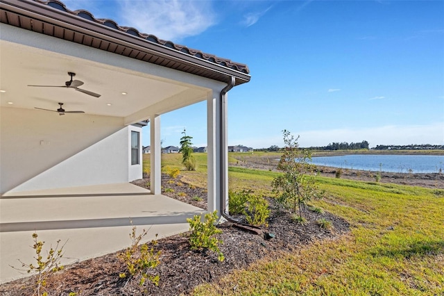 exterior space featuring a water view and ceiling fan