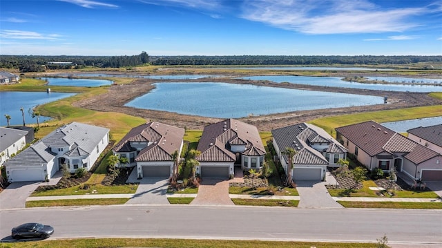 birds eye view of property with a residential view and a water view