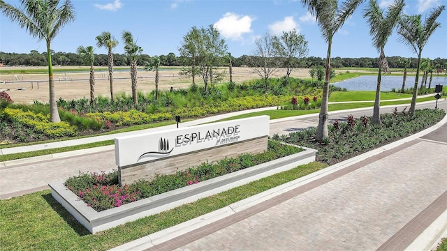 community / neighborhood sign with a water view