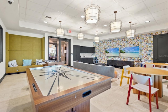 playroom featuring light tile patterned floors, visible vents, wallpapered walls, a paneled ceiling, and an accent wall