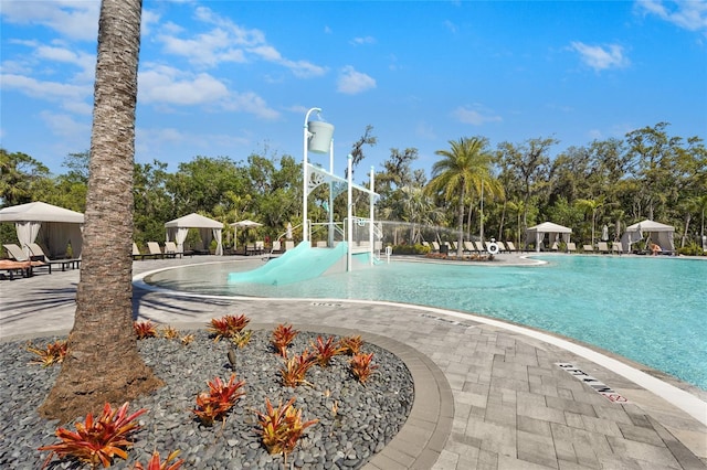 community pool with a gazebo and a patio