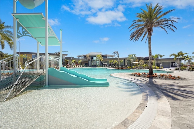 pool with a water slide and a water play area