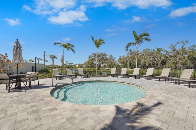 view of pool featuring a patio and fence