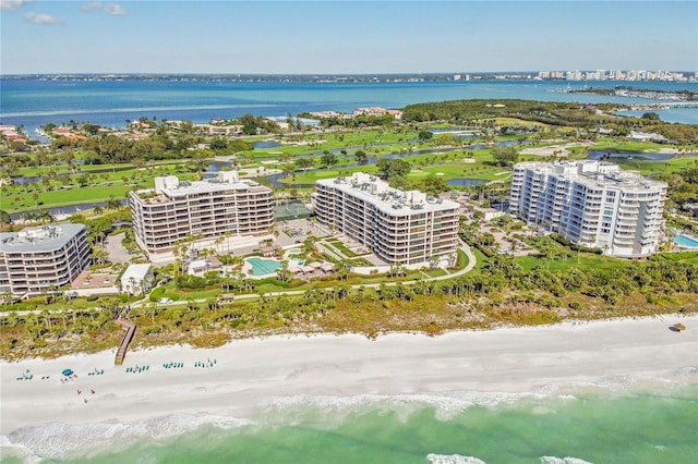 birds eye view of property featuring a water view and a beach view