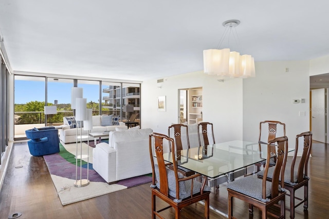 dining room with floor to ceiling windows, dark hardwood / wood-style flooring, and a chandelier