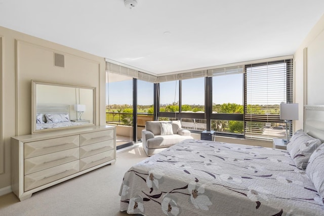 bedroom with light carpet and expansive windows