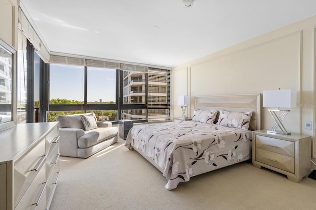 carpeted bedroom featuring expansive windows