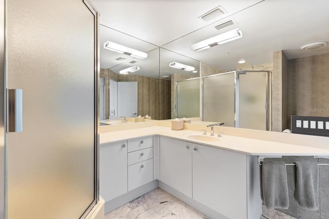 bathroom featuring vanity and a shower with shower door