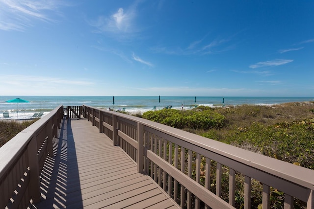 view of community featuring a beach view and a water view