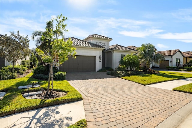 mediterranean / spanish-style home with a front yard and a garage