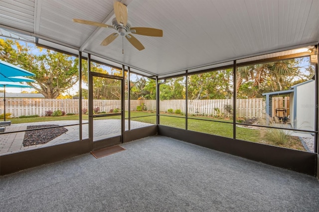 unfurnished sunroom with ceiling fan