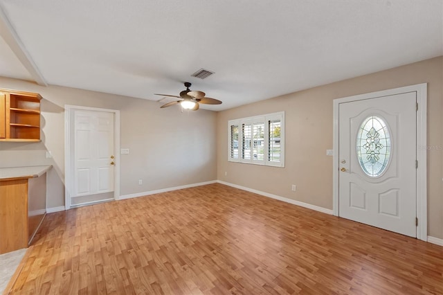 foyer entrance with ceiling fan and light hardwood / wood-style flooring