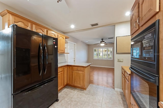 kitchen featuring kitchen peninsula, light tile patterned floors, ceiling fan, and black appliances