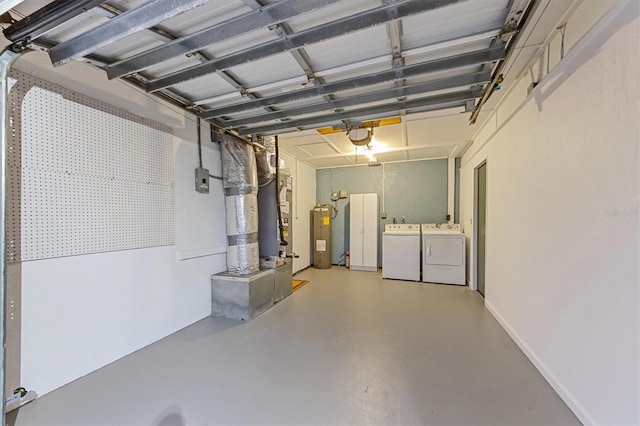 garage with water heater and washer and dryer