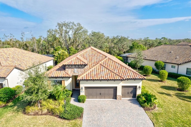 mediterranean / spanish-style home with a garage and a front lawn