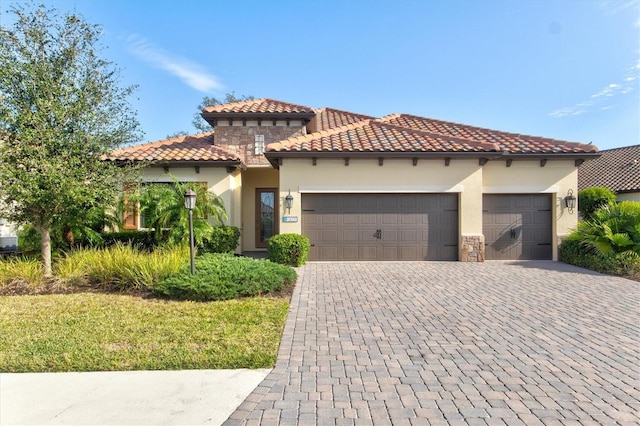 mediterranean / spanish home featuring a garage