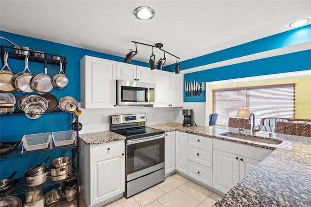 584 Beverly Rd, Venice, FL 34293 - kitchen featuring appliances with stainless steel finishes, white cabinets, dark stone counters, and backsplash