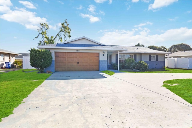 ranch-style house featuring a garage and a front lawn