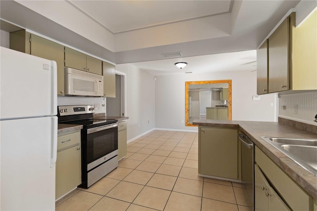 kitchen with kitchen peninsula, stainless steel appliances, sink, light tile patterned floors, and green cabinets