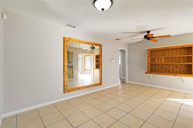 tiled spare room with a textured ceiling