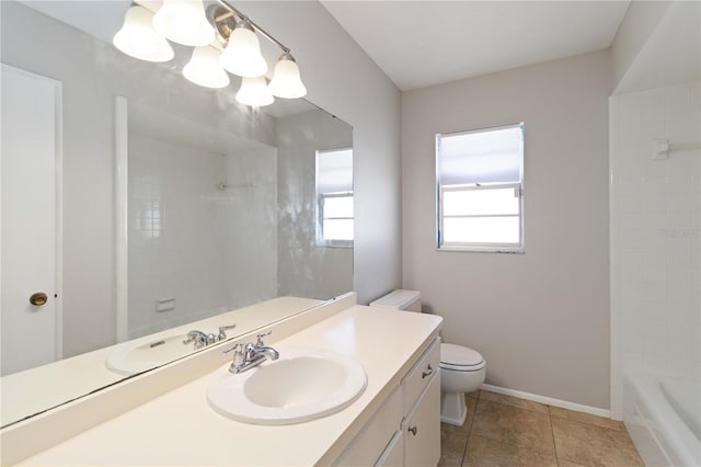 bathroom featuring tile patterned floors, vanity, toilet, and a notable chandelier