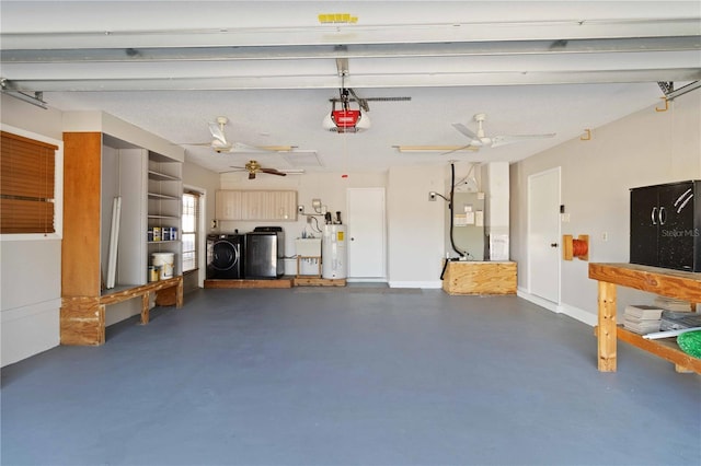 garage featuring washing machine and clothes dryer, sink, electric water heater, heating unit, and a garage door opener