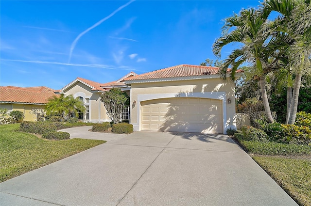 mediterranean / spanish house featuring a front yard and a garage