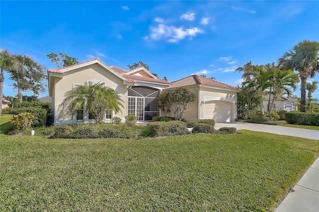 mediterranean / spanish home with a front yard and a garage